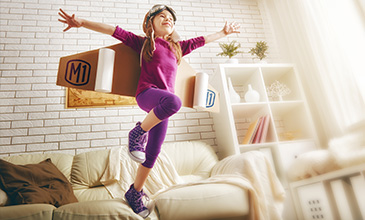 Youth jumping on couch