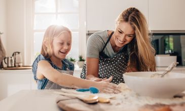 Woman and daughter baking in kitchen