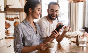 Having coffee looking at device